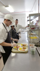 Cafe ML chefs preparing tray of food